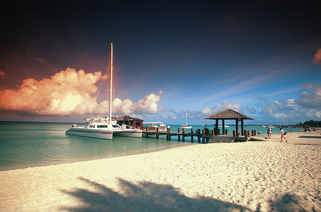 Catamaran docked at pier at sunset on Aruba, Caribbean